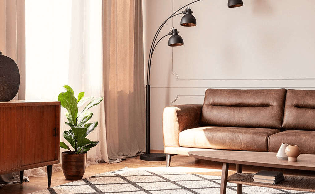Living room with Brown leather couch and black metal floor lamp